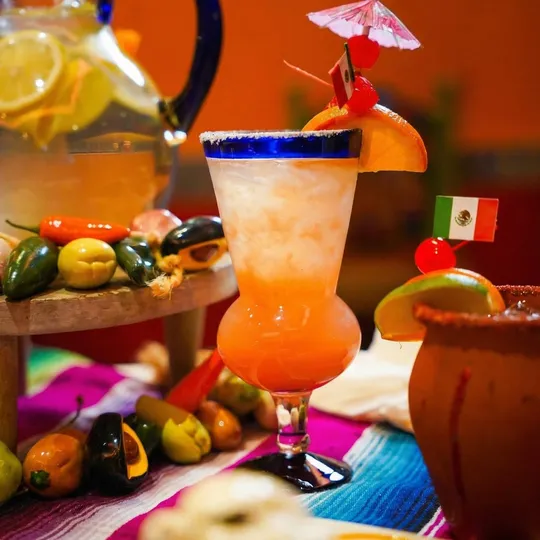 Frozen peach cocktail in hurricane glass at Ixtapa Mexican Restaurant, Lunenburg MA